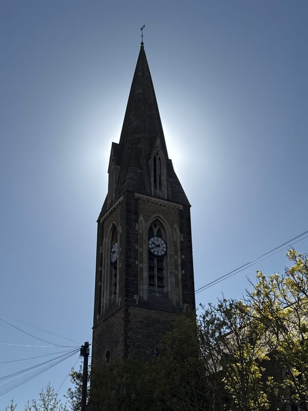 Historic church spire photographed under clear skies in Northampton