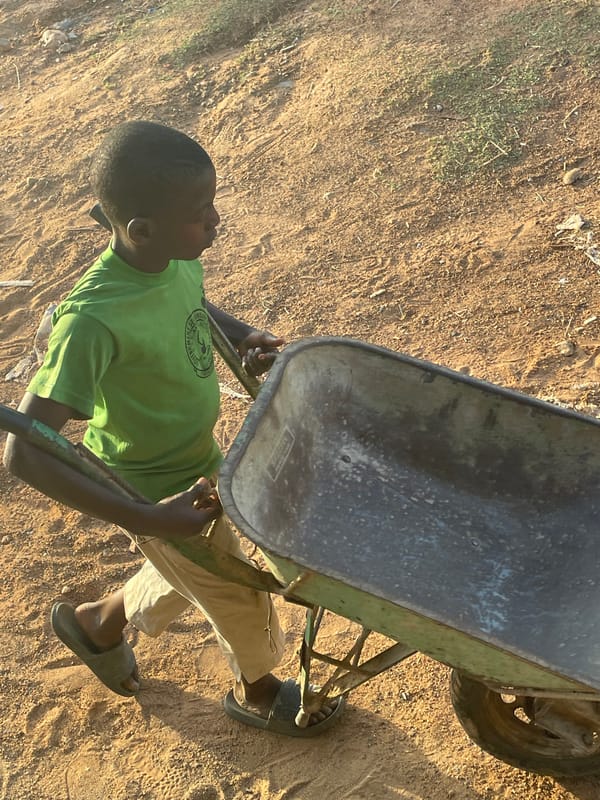 People engage in outdoor activities on dirt field in Akwanga