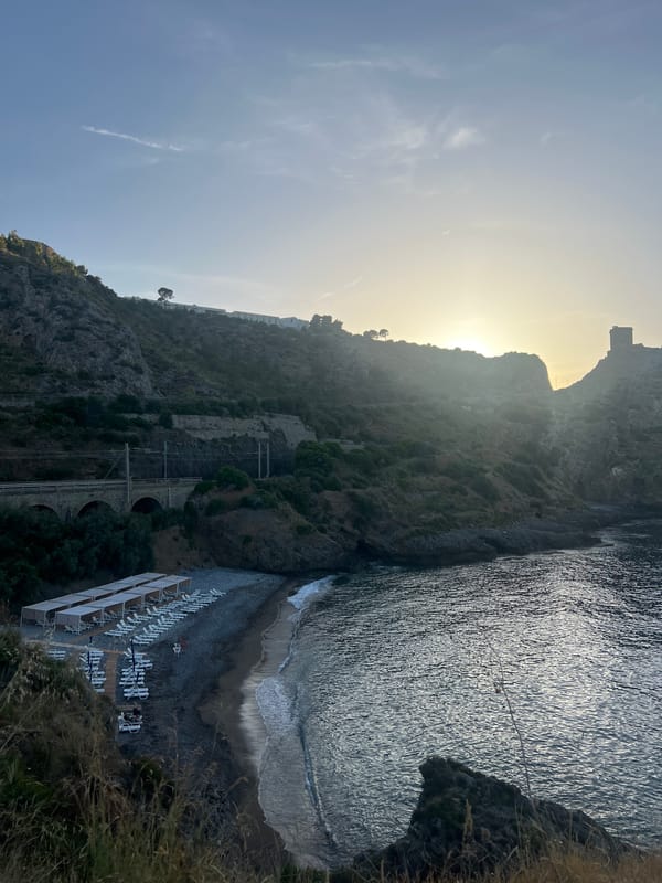 Tourists explore coastal cliffs and caves in Sperone, Italy