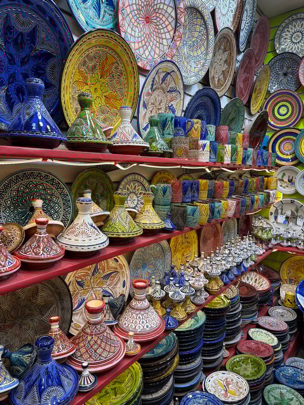 Tourists browse busy market stalls in Marrakesh thoroughfare