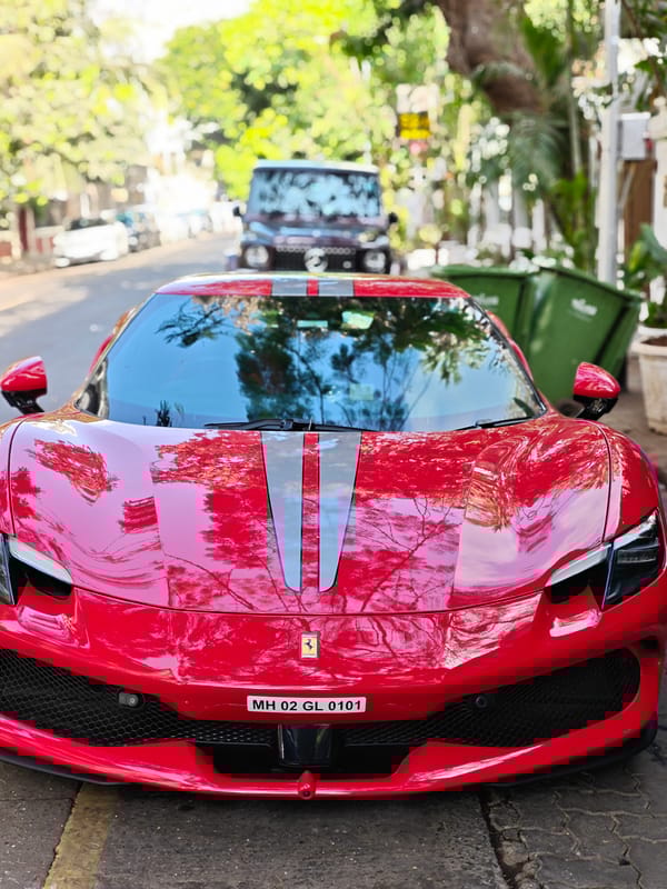 Red Ferrari draws attention on Mumbai street amid casual moments