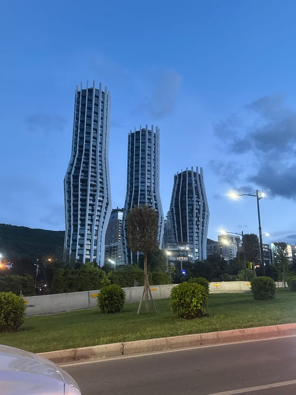 Modern wavy towers photographed in Tbilisi evening sky