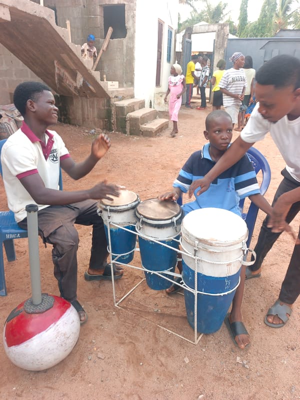 Children gather for outdoor drumming session in Akwanga, Nigeria