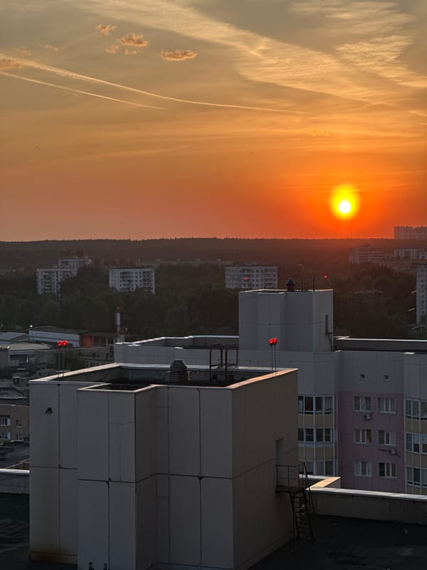 Sunset observed over Zhukovka cityscape with orange skies