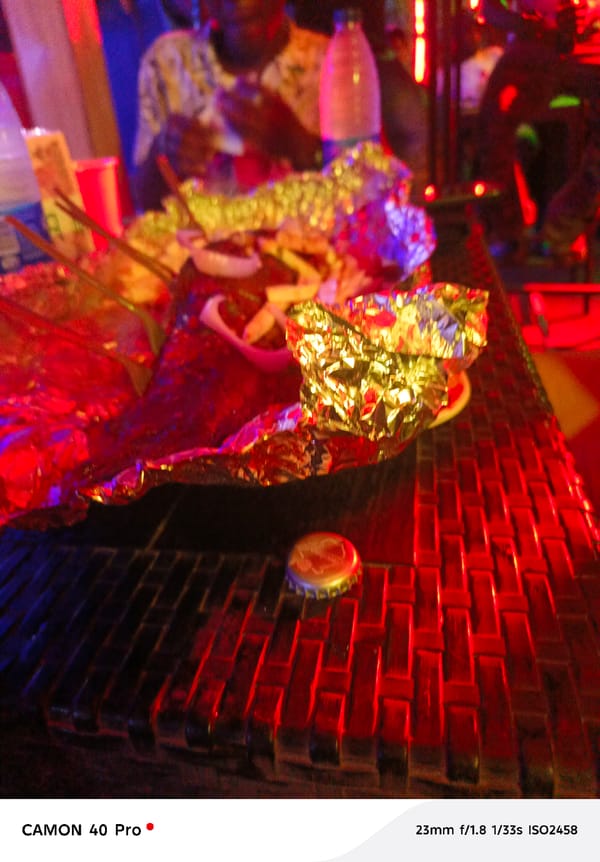 Indoor gathering documented by witnesses with food, red lighting