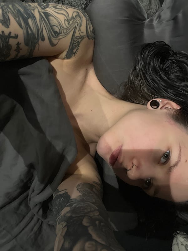Tattooed individual resting in bed observed in Khimki