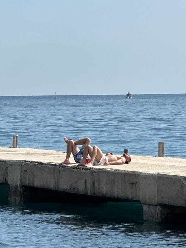 Beachgoers enjoy typical afternoon at Budva's Adriatic coast
