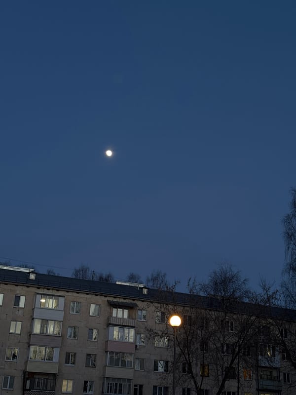 Nighttime apartment building illuminated by street lighting in Izhevsk