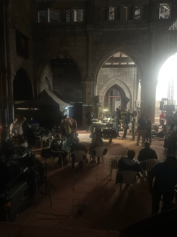 Film set or event preparation documented in Mumbai stone building