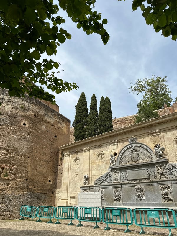 Tourist documents Granada's historic sites and gardens during afternoon visit