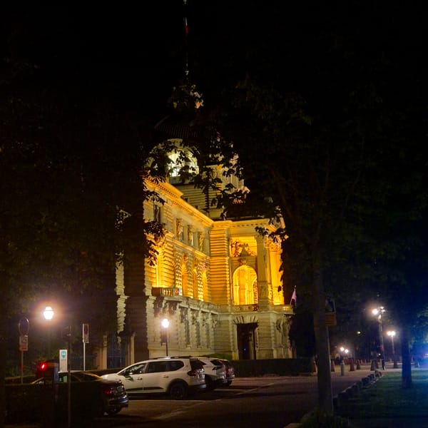 Ornate stone building illuminated at night in Strasbourg