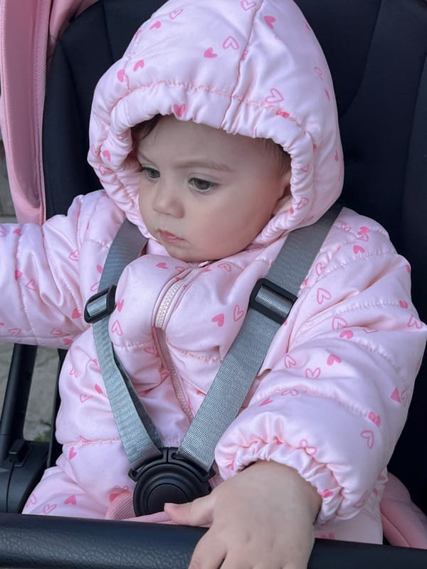 Baby in pink heart jacket photographed in Elena, Bulgaria