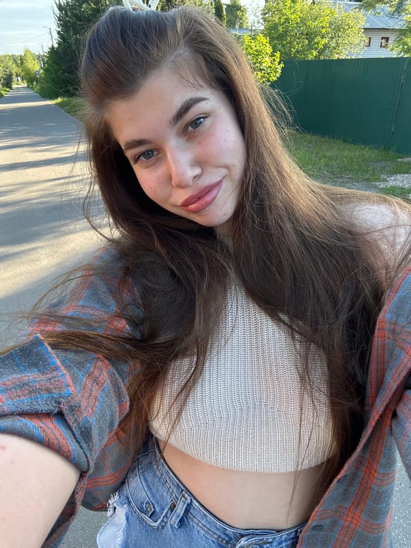 Woman takes selfies during sunny walk in Мещёры, Russia