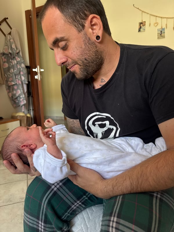 Father holds baby at home in Aprilia, Italy