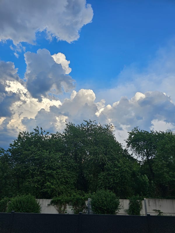 Residential streets and shifting skies on a cloudy afternoon