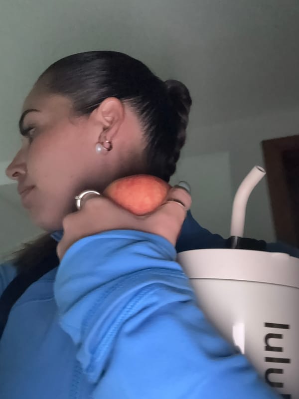 Woman with peach, water tumbler observed in Tlaxcalancingo