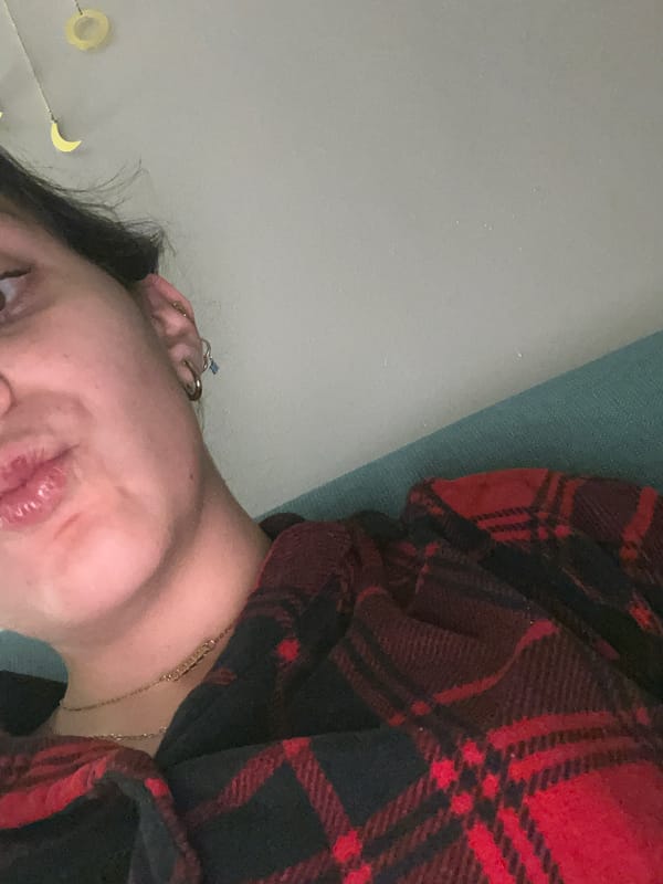 Person reads Spanish book in plaid clothing, Mexico City