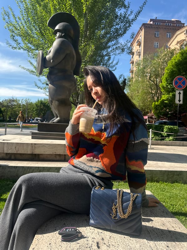 Woman enjoys morning drink with luxury accessories in Yerevan