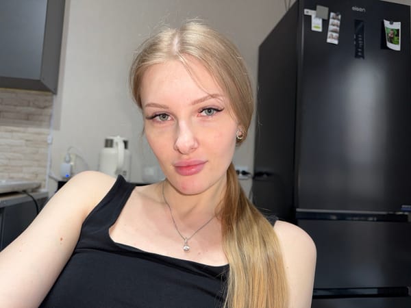 Woman takes selfie in white jacket in Perm