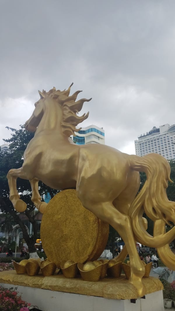 Golden horse statue, flagpole documented in Nha Trang square