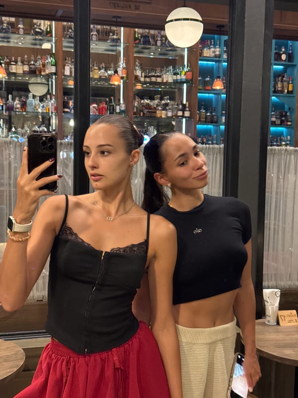 Two women take selfies at upscale Phuket bar