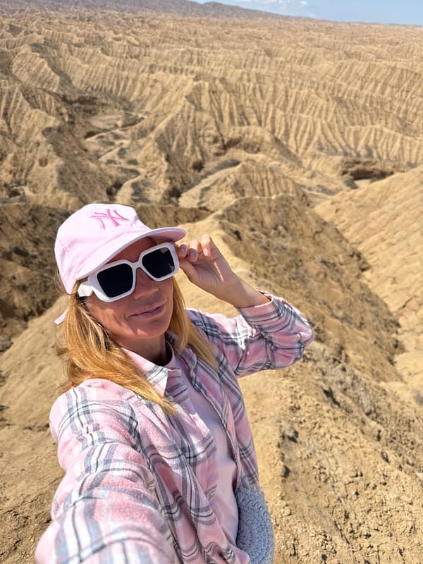 Tourists explore dramatic badlands formations near Tong, Kyrgyzstan