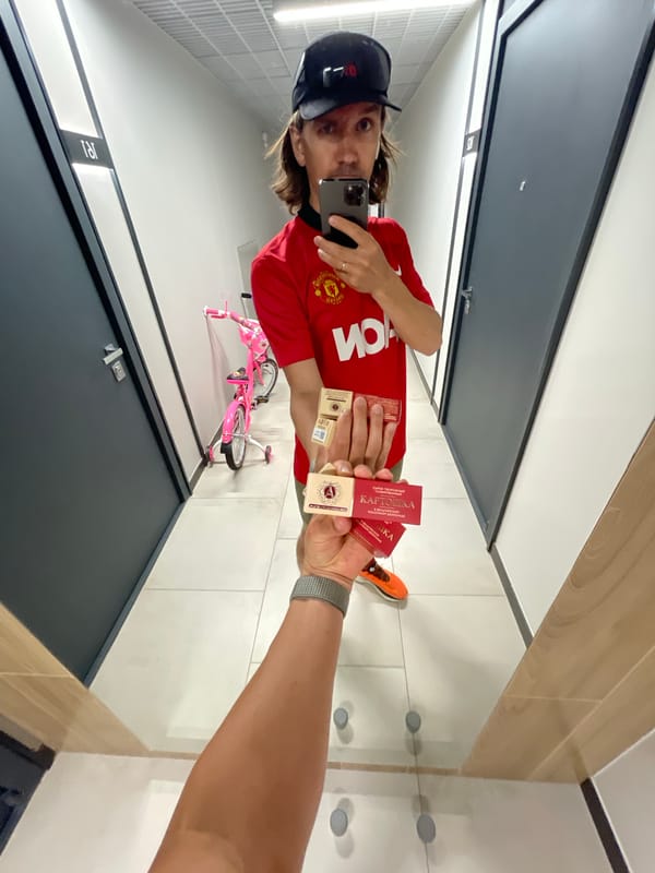 Manchester United fan documents snack shopping with multiple selfies
