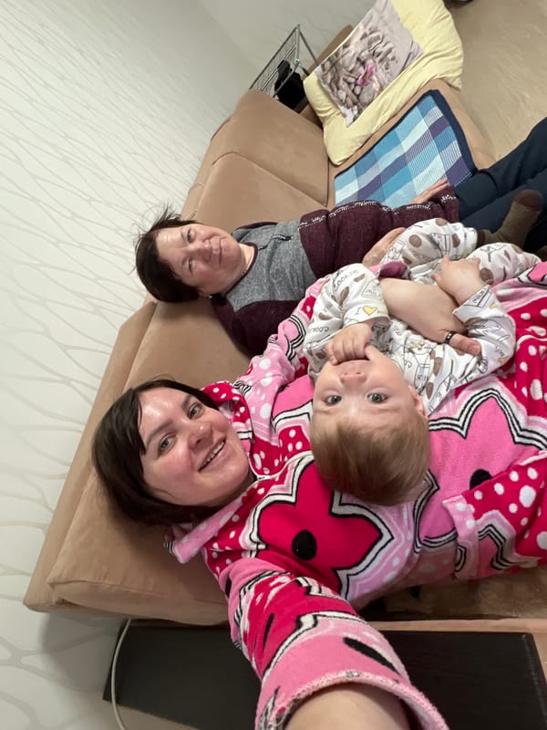 Family rests together on couch in Perm home