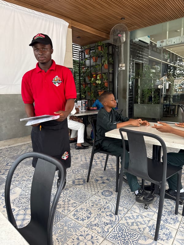 Diners gather at outdoor café in Abuja during morning hours