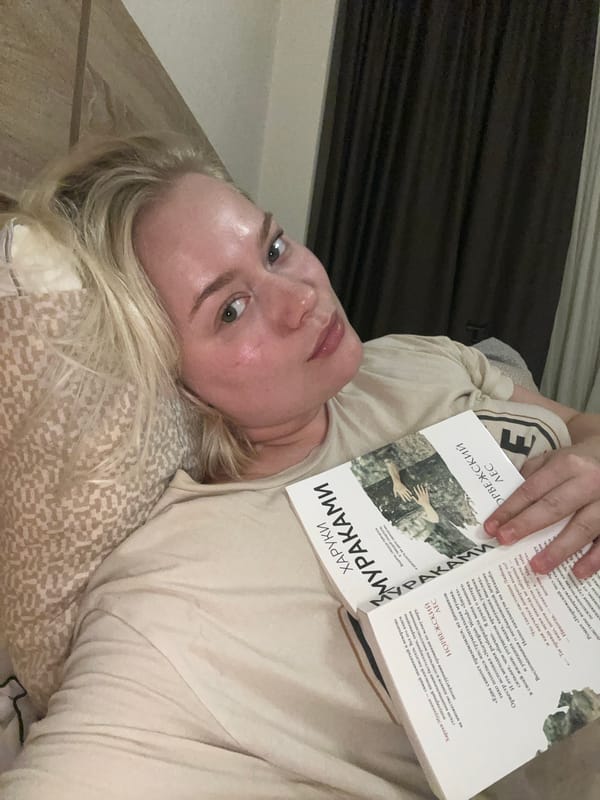 Woman reads Russian literature in Tbilisi bedroom