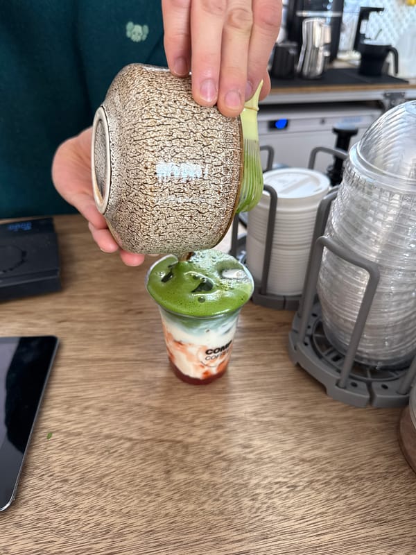 Person handles ceramics at London cafe counter
