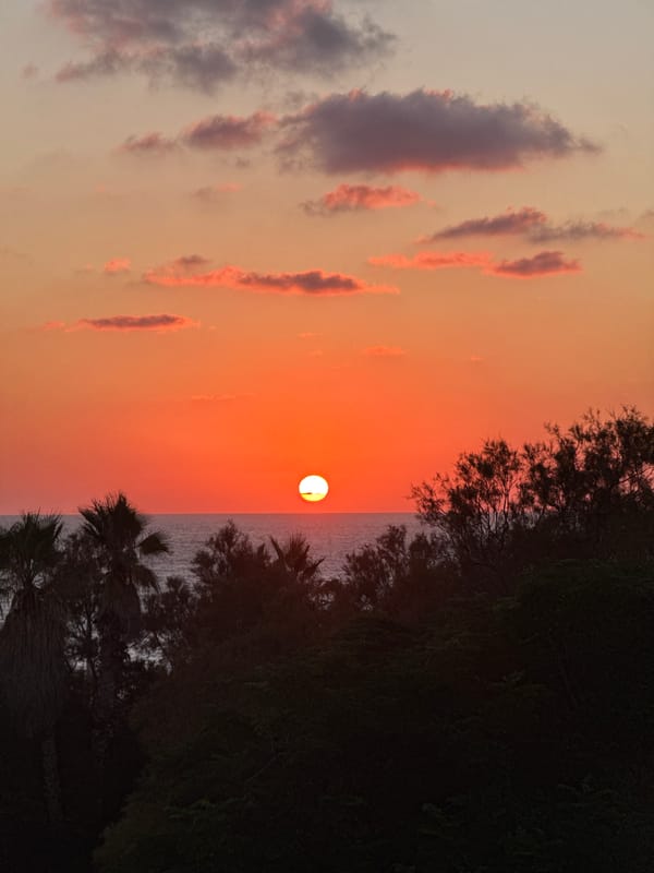 Mediterranean sunset from Tel Aviv's shore, golden hour.
