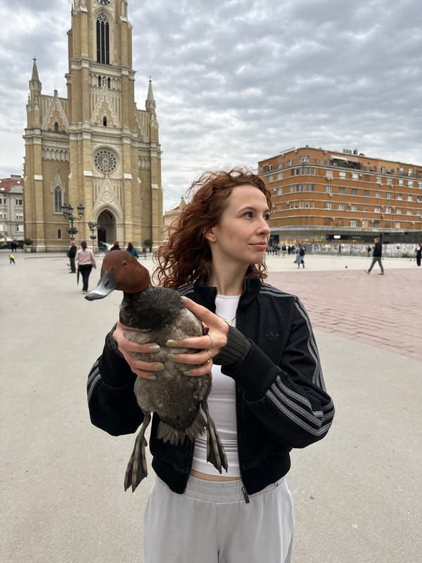 Woman holds duck in Novi Sad public square