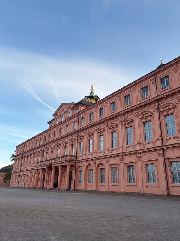 Pink ornate building with golden dome observed in Rastatt