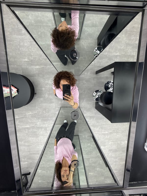 Woman takes mirror selfie in retail shop