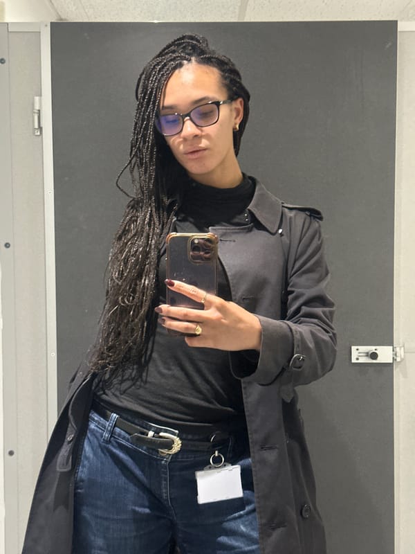 Person takes indoor selfie in London wearing black outfit