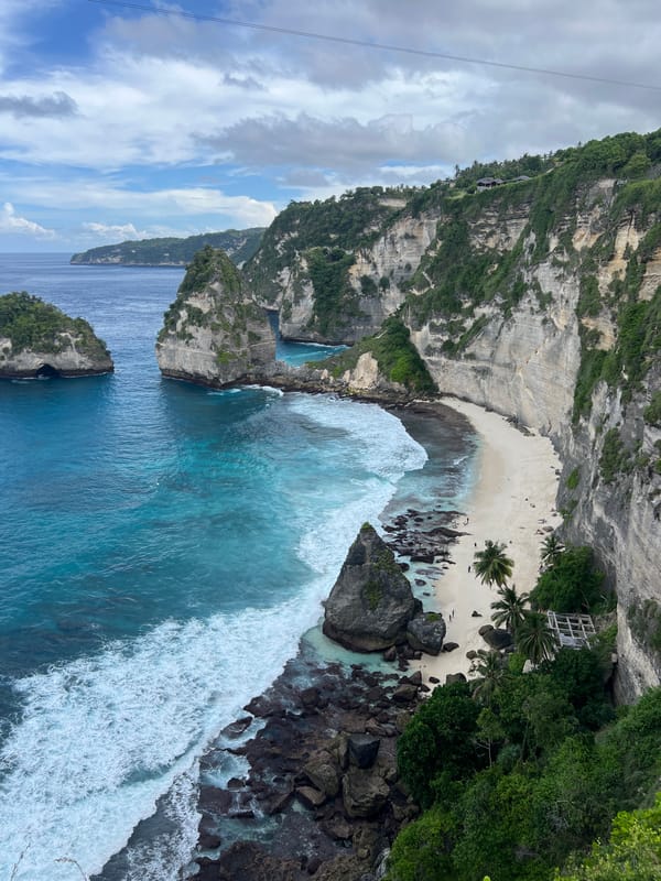 Early morning tourists gather at Nusa Penida's Diamond Beach cliffs