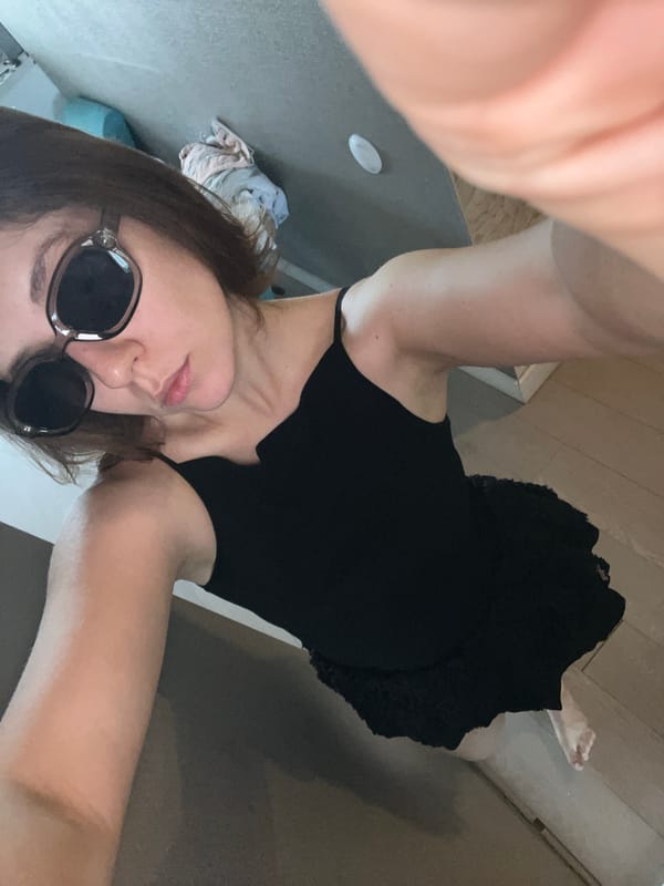 Woman takes indoor selfies in black dress in Krasnoyarsk