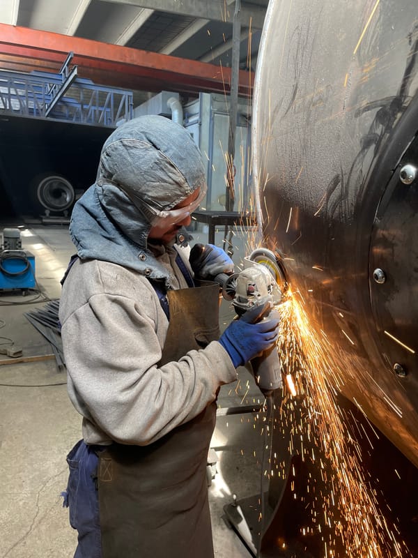 Welder works on metal object in Zaljevo, Montenegro