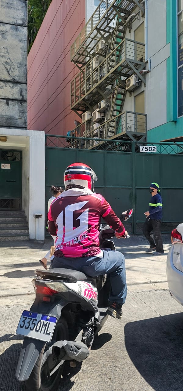 Midday traffic and street life at Makati's Dela Rosa Square