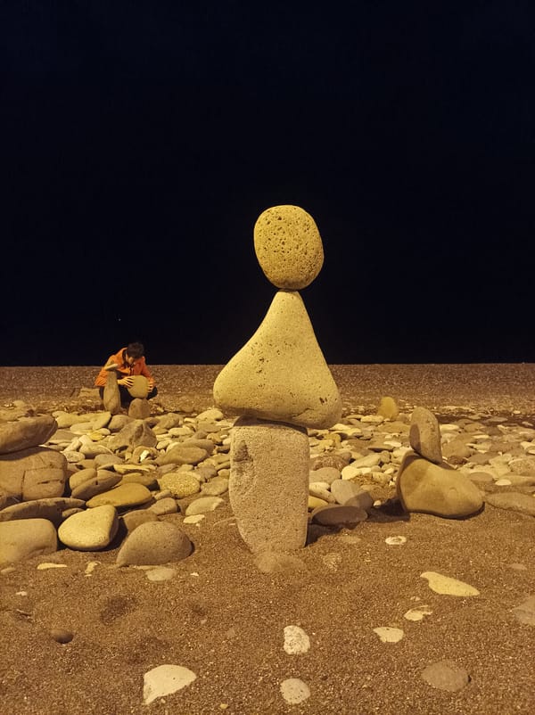 Stone stacking artist creates rock sculptures on Batumi beach