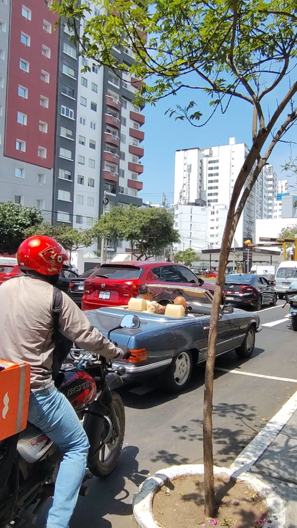 Delivery driver pauses in traffic in Miraflores, Peru