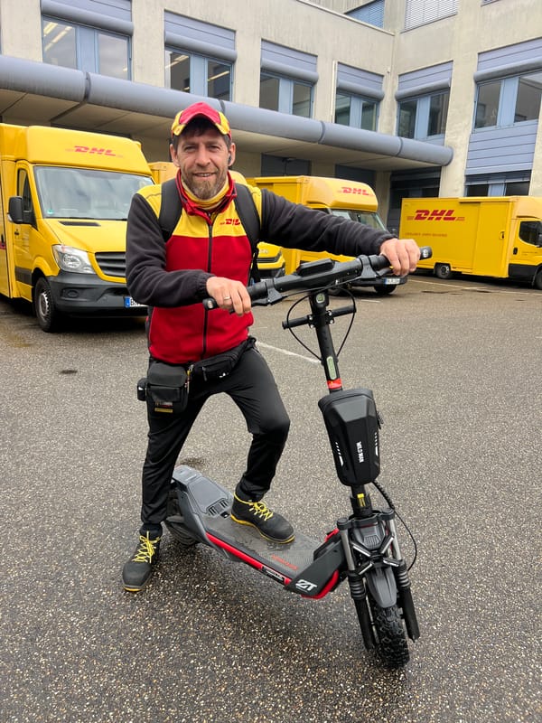 DHL worker takes break with electric scooter in Germany