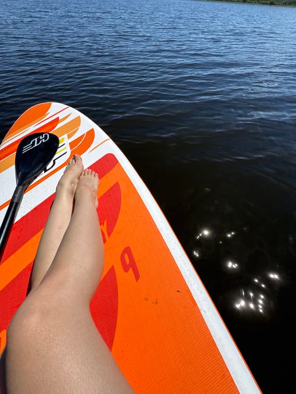 Lazy morning on a paddleboard, lake in Latvia