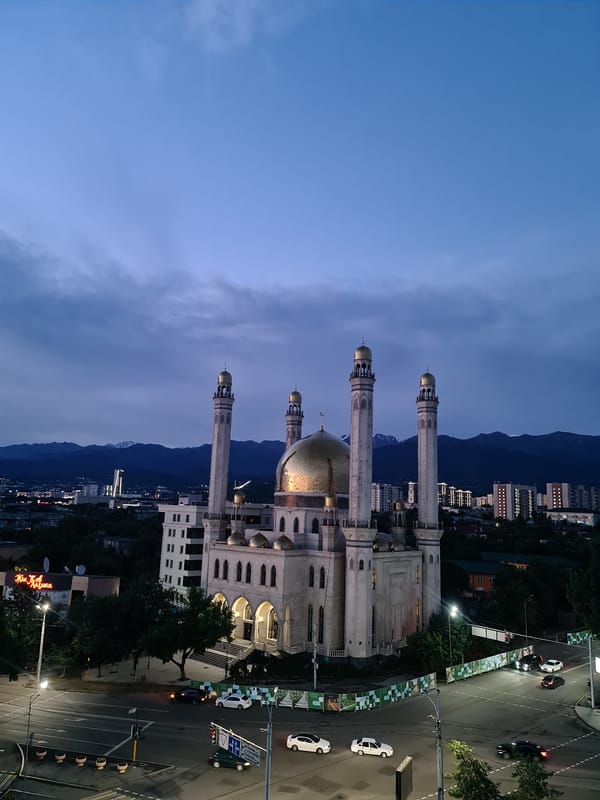 Almaty skyline and Central Mosque at golden hour dusk