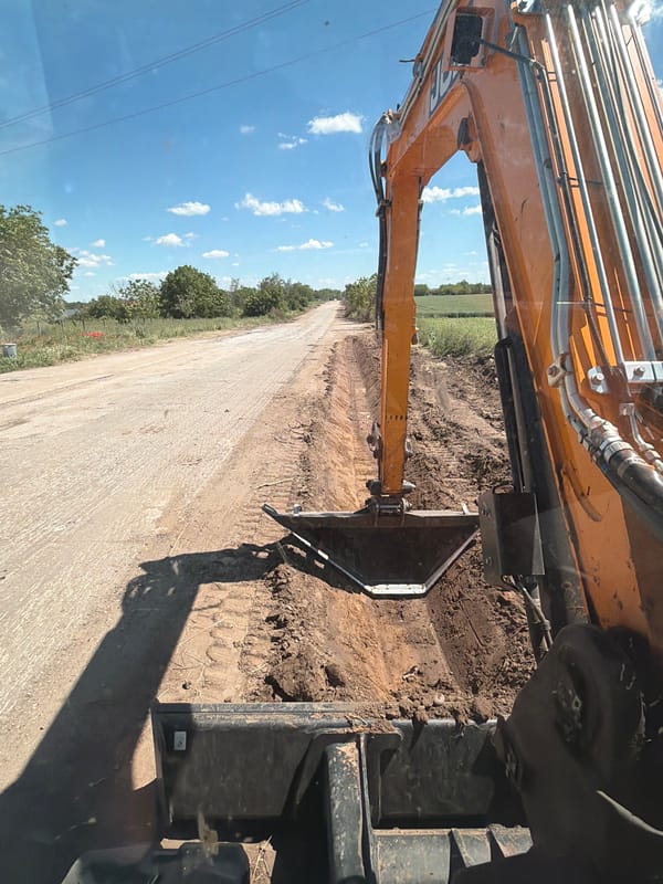 Excavator performs roadwork on dirt road in Oryahovo, Bulgaria