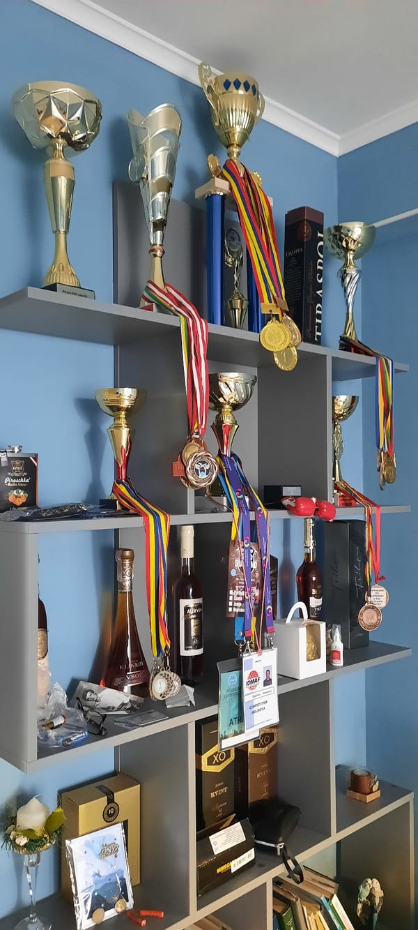 Trophies, clocks, and sneakers in a Chișinău room