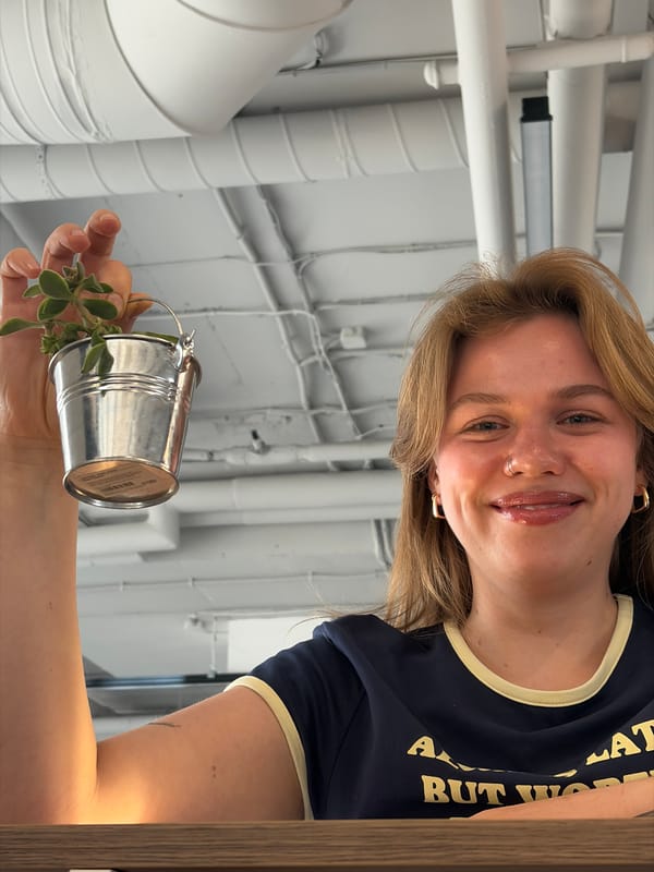 Woman poses with potted plant in rural Belarus