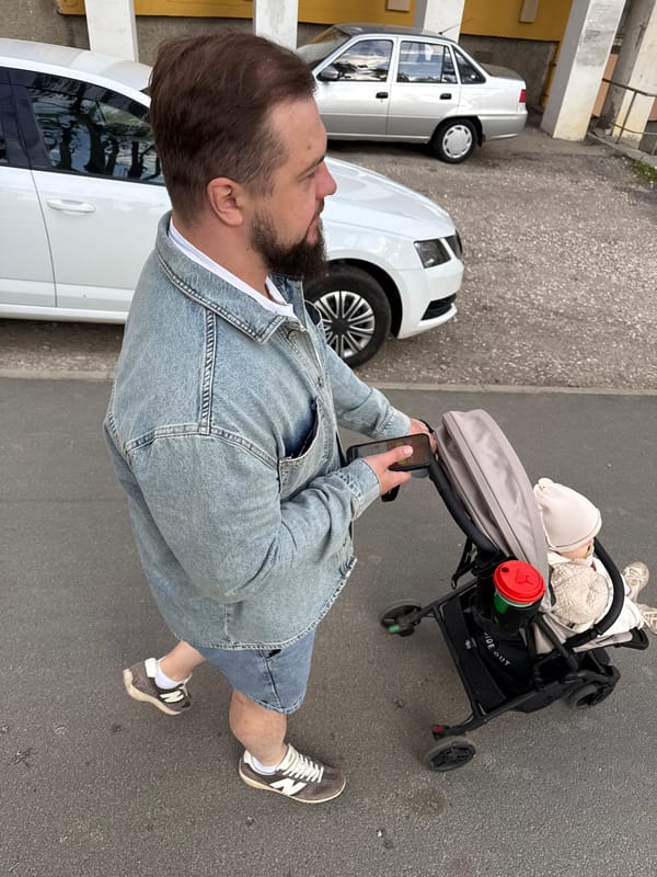 Family strolls through Vladimir streets with baby in afternoon