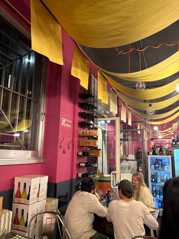 Decorated interior space documented in Milan with hanging yellow cloth